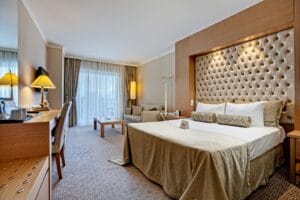 Amara Wing Resort, guestroom with upholstered tufted headboard by Cocoplum