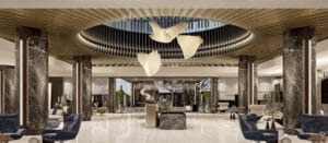 Alba Hotel lobby with stone columns, sculptural lighting and durable hospitality finishes.