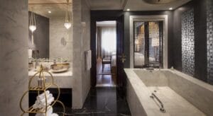 Jumeirah Zabeel Saray, Dubai: guest bathroom with marble bath and carved lattice screens, FF&E designed and produced by Cocoplum Design Studio